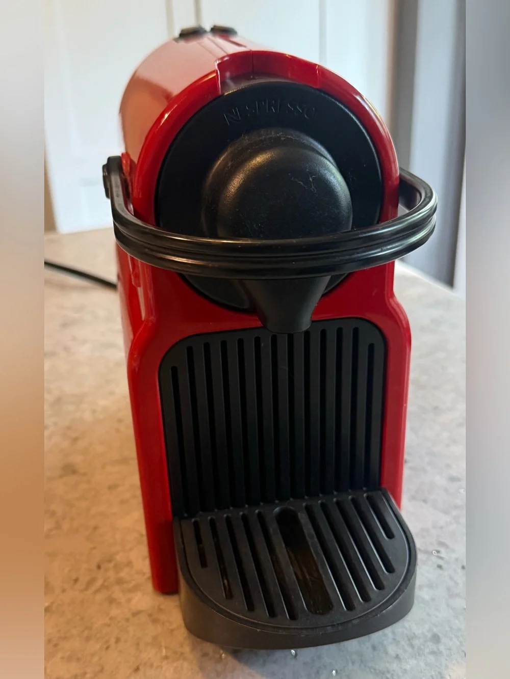 Nespresso Red Single-Serve Espresso Machine with Black Accents.